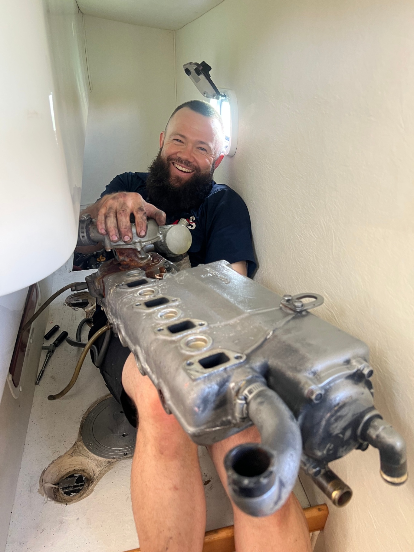 HDS technician pulling a manifold off one of the Yanmar 4JH3-DTE engines