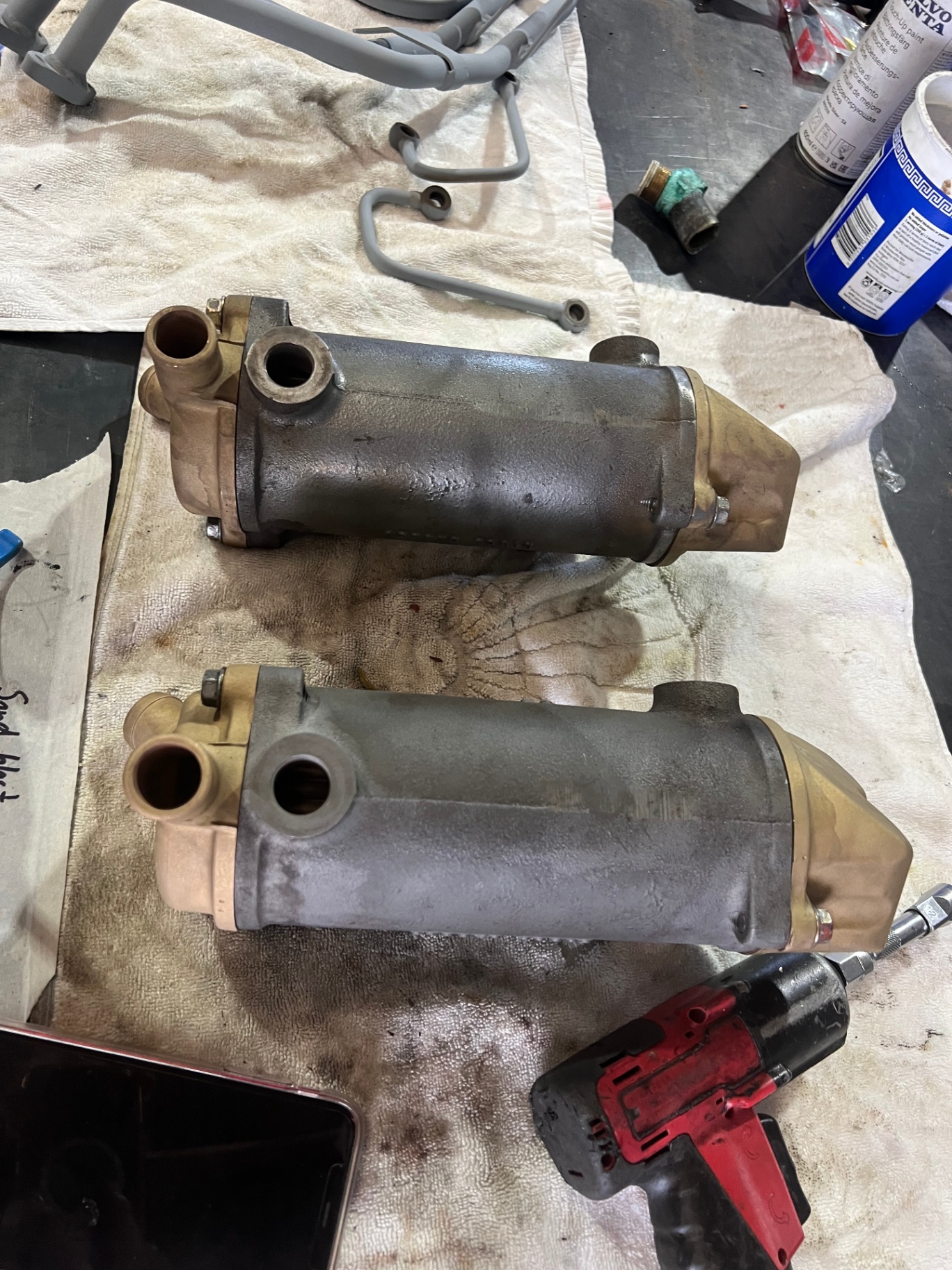 Aftercooler housings on the bench showing corrosion before replacement