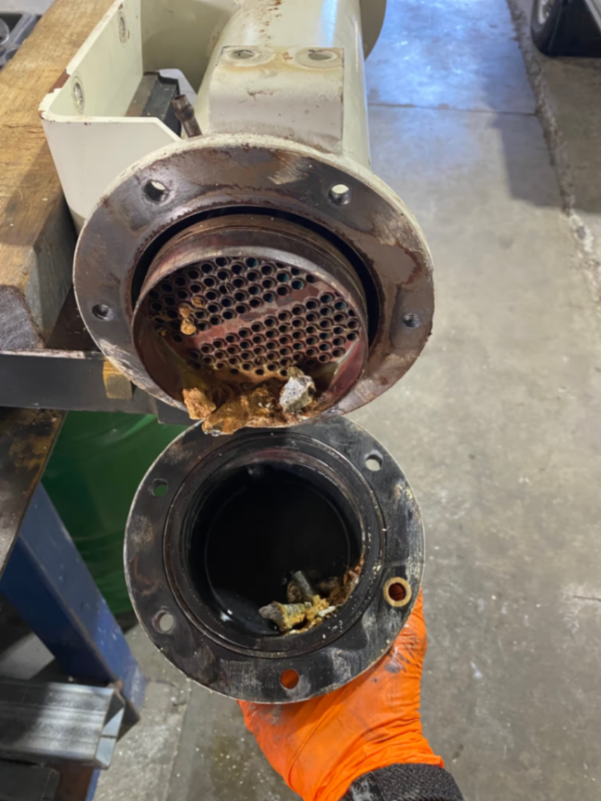 Heat exchanger end cap removed showing salt and scale build-up